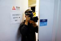 A member of media is seen next to the logo of Citizen News in Hong Kong