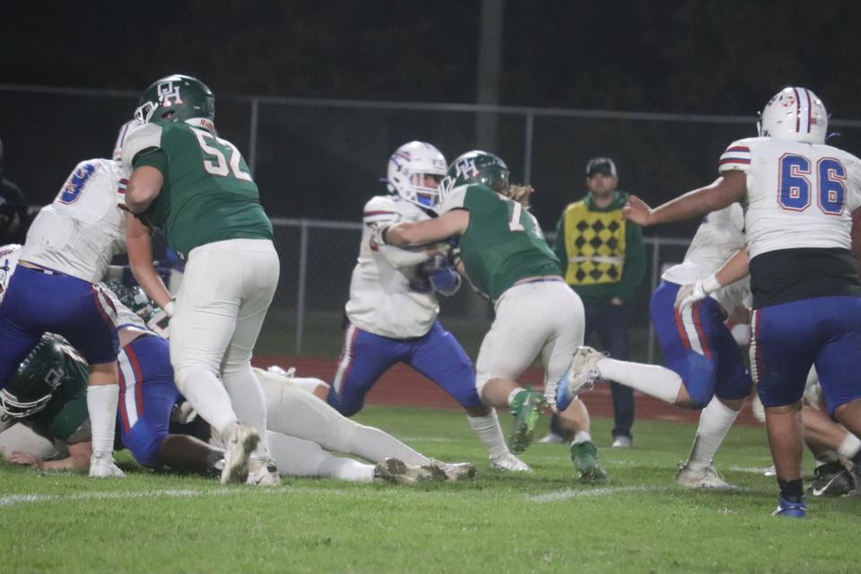 Oak Harbor's Garrett Lindsay tries to push a defender back.