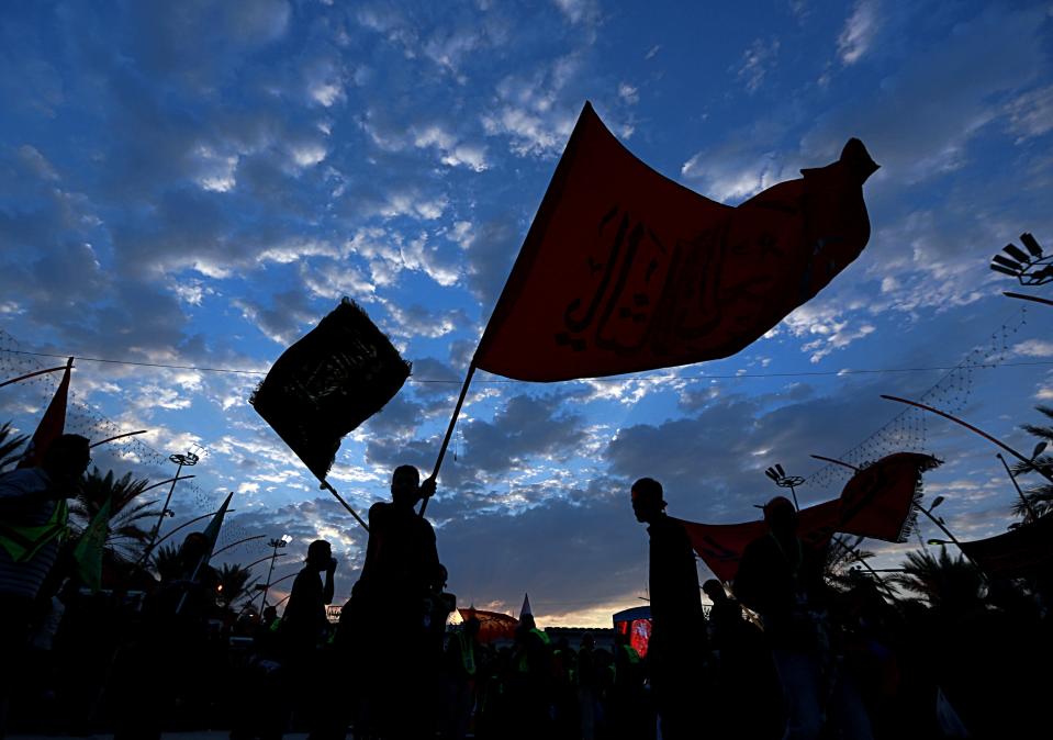 Shiite pilgrims march to the holy shrines of Imam Hussein and Imam Abbas ahead of the Arbaeen festival in Karbala, Iraq, Friday, Oct. 18, 2019. The holiday marks the end of the forty day mourning period after the anniversary of the martyrdom of Imam Hussein, the Prophet Muhammad's grandson in the 7th century. (AP Photo/Hadi Mizban)
