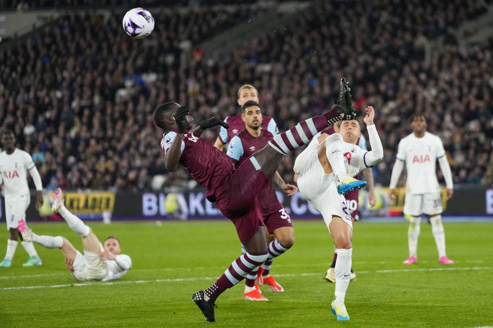 West Ham's Kurt Zouma, left, duels for the ball with Tottenham's Pedro Porro during the English Premier League soccer match between West Ham and Tottenham, at the London stadium in London, Tuesday, April 2, 2024. (AP Photo/Kirsty Wigglesworth)