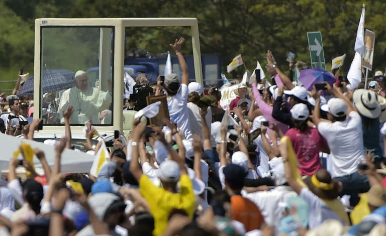 Pope Francis waves from the popemobile upon arrival for an open-air mass at Samanes Park in Guayaquil, Ecuador on July 6, 2015