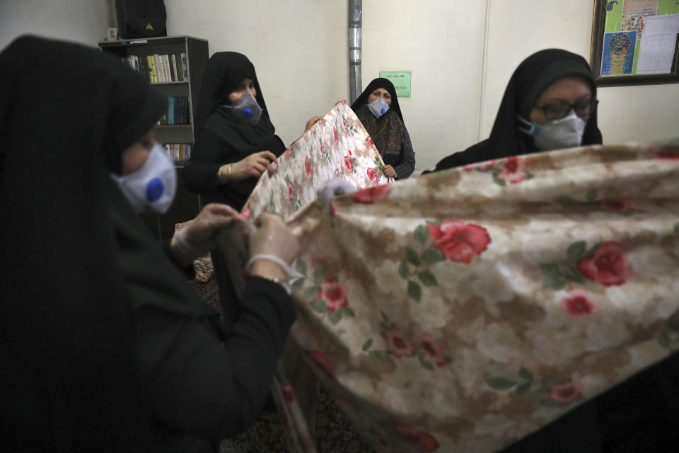 Volunteer women prepare fabric to sew bed sheets for hospitals, in a mosque in southern Tehran, Iran, April 5, 2020. (AP Photo/Vahid Salemi)