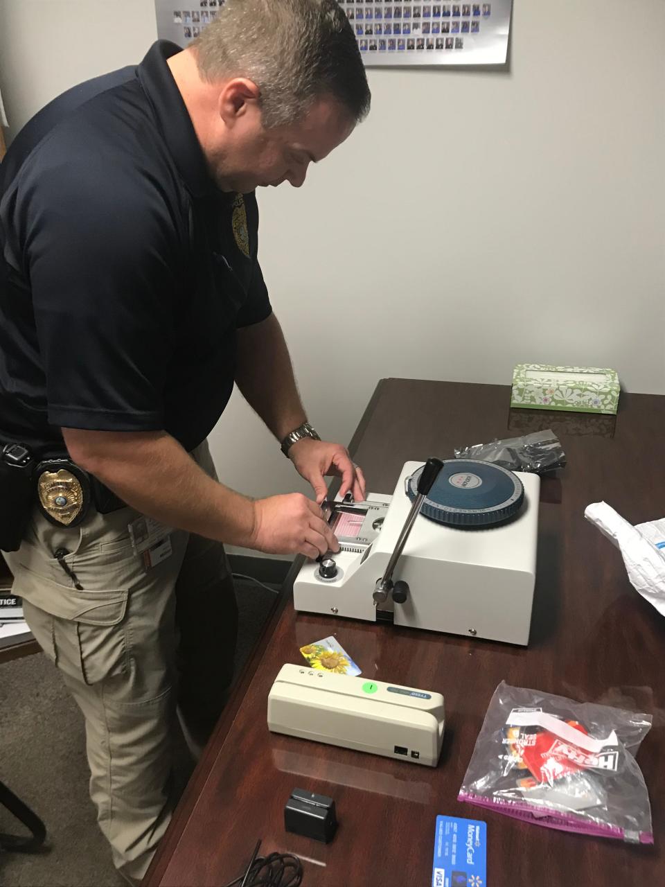 Tallahassee Police Sgt. Adam Miller, who oversaw an investigation into a 2019 foreign cyber-attack of the city's direct deposit payroll in April, displays a credit card maker.