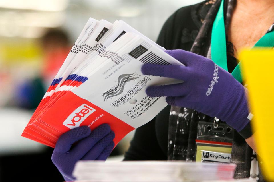 An election worker sorts vote-by-mail ballots for the presidential primary at King County Elections in Renton, Wash., on March 10, 2020.