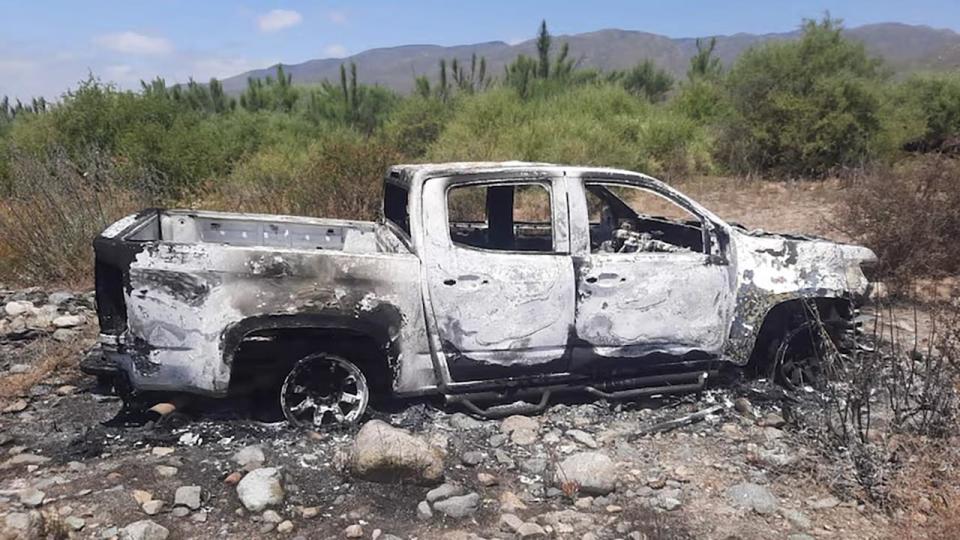 A burnt out car at a ranch several kilometres from the search site. .