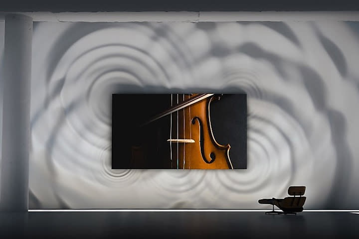 Samsung microLED TV mounted on a wall showing a violin with a seat in front of it.