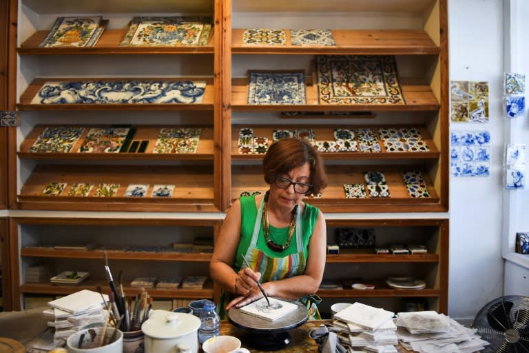 Ceramist Cristina Pina makes replicas to sell to tourists so they don't have to buy those stolen from buildings