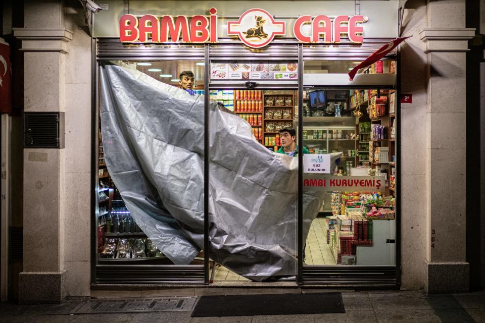 Most retail stores, cafes, restaurants and bars have closed in Istanbul, Turkey, as precautionary measures against the fast spreading coronavirus pandemic, also know as the Covid-19. Pictured above, workers at the iconic Bambi Cafe near Taksim Square hang a tarp over the entrance of the popular tourist fast food destination on March 25.