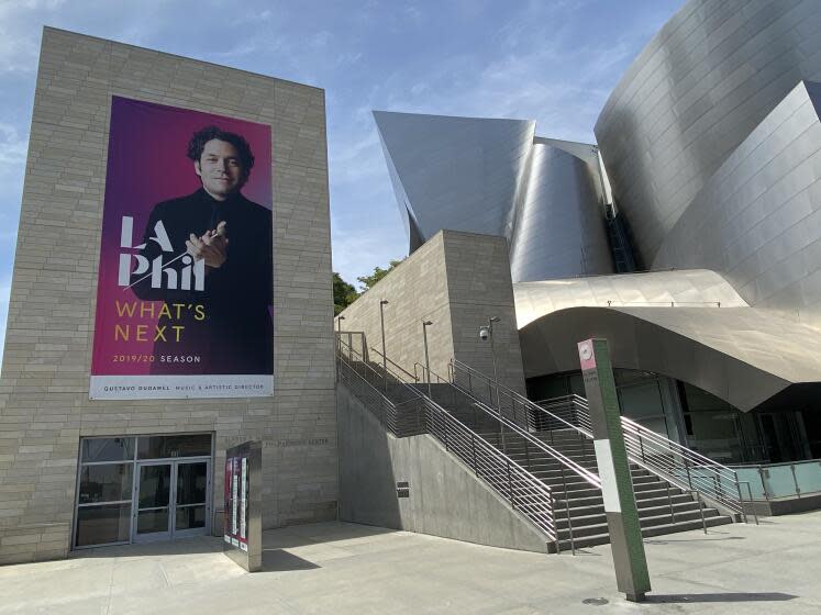 An L.A. Phil poster depicting Gustavo Dudamel is displayed outside the Walt Disney Concert Hall