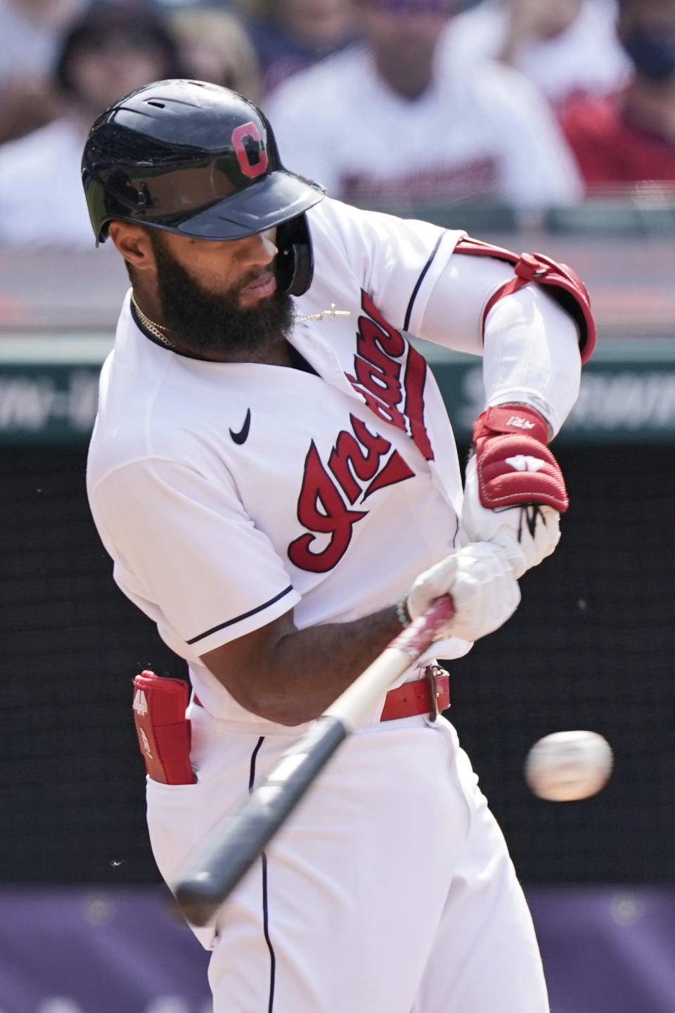 Cleveland Indians' Amed Rosario hits a single in the ninth inning of a baseball game against the Minnesota Twins, Sunday, May 23, 2021, in Cleveland. (AP Photo/Tony Dejak)