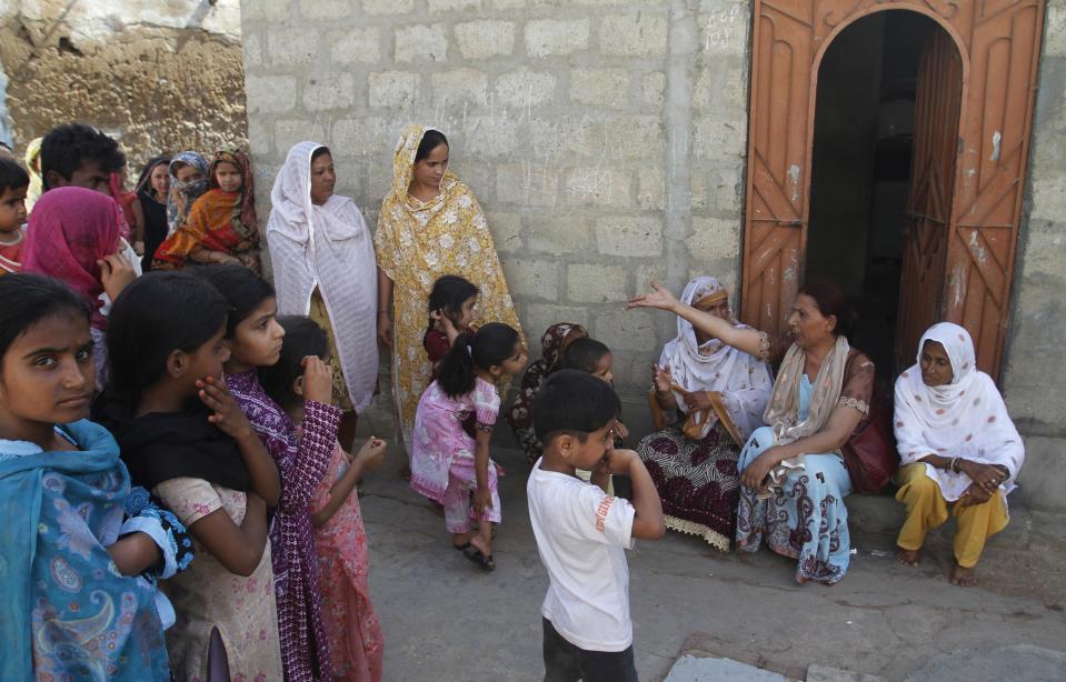 In this picture taken on Monday, April 15, 2013, Bindiya Rana, second right, a transgender candidate in Pakistan's elections, interacts with locals in Karachi, Pakistan. When Rana went door to door in the Karachi slum she hopes to represent, few people seemed to care about which gender she identifies with. They were more interested in what she was going to do to combat the street crime and electricity outages in their neighborhood if elected.(AP Photo/Shakil Adil)