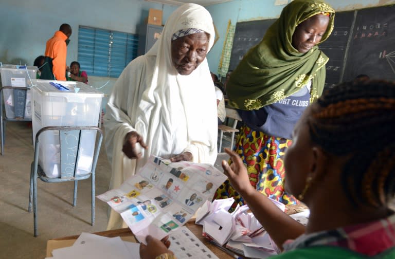 Women prepare to cast their vote for the presidential election at a polling station in Ouagadougou on November 29, 2015