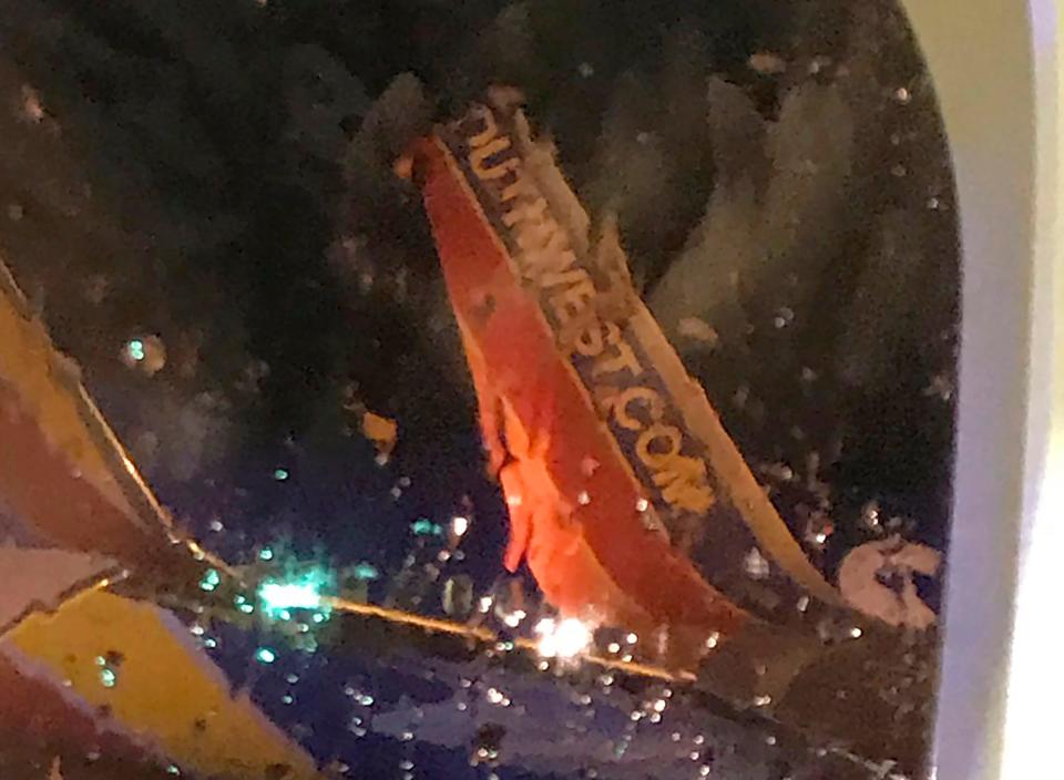 This photo taken on board by a passenger on a Southwest Airlines flight to Atlanta appears to show the top fin of another Southwest Airlines plane clipped off after the planes collided on Saturday night on the tarmac of Nashville International Airport in Tennessee. The airline says both planes returned to the gate under their own power and were taken out of service for evaluation. No one was injured.
