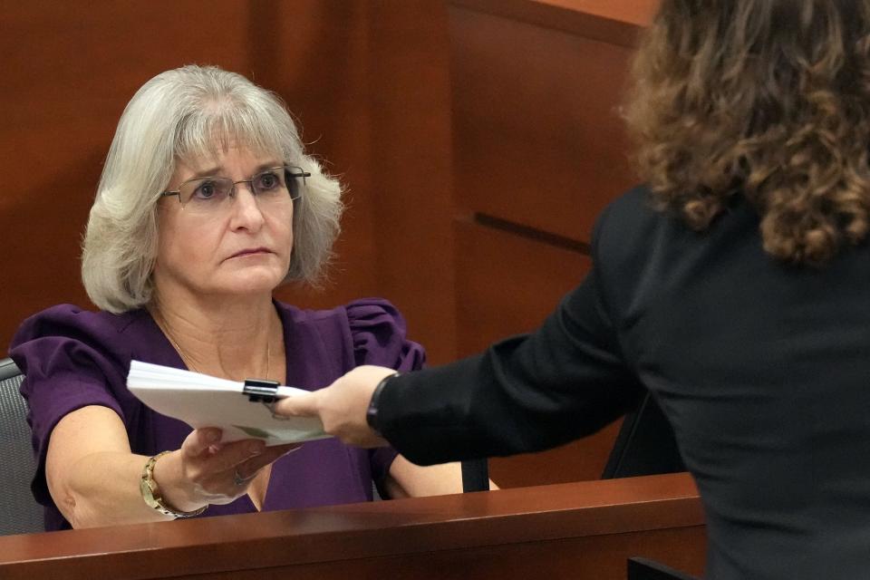 Child and adolescent psychiatrist Dr. Laurie Karpf hands paperwork back to Assistant Public Defender Tamara Curtis as she testifies during the penalty phase of the trial of Marjory Stoneman Douglas High School shooter Nikolas Cruz at the Broward County Courthouse in Fort Lauderdale on Thursday, August 25, 2022. Karpf treated Cruz as an adolescent. Cruz previously plead guilty to all 17 counts of premeditated murder and 17 counts of attempted murder in the 2018 shootings.