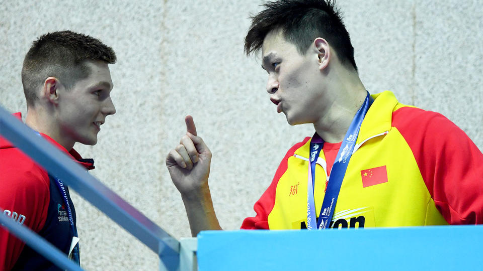 Sun Yang speaks with Duncan Scott after the medal ceremony for the 200m final. (Photo by Quinn Rooney/Getty Images)