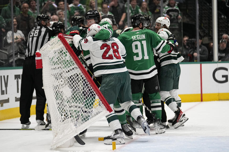 Minnesota Wild center Gustav Nyquist (28) and Dallas Stars defenseman Thomas Harley (55) knock the net over as they scuffle during the second period of Game 5 of an NHL hockey Stanley Cup first-round playoff series, Tuesday, April 25, 2023, in Dallas. (AP Photo/Tony Gutierrez)