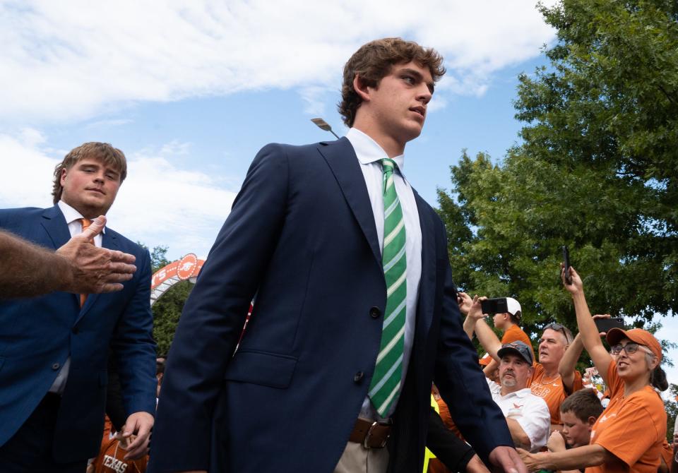 Texas quarterback Arch Manning walks past fans lined up along Bevo Boulevard ahead of the Texas Longhorns' game against the Wyoming Cowboys, Saturday, Sept. 16 at Darrell K Royal-Texas Memorial Stadium in Austin.