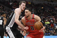 San Antonio Spurs center Jakob Poeltl (25) defends against Chicago Bulls guard Zach LaVine (8) during the first half of an NBA basketball game Monday, Jan. 27, 2020, in Chicago. (AP Photo/David Banks)