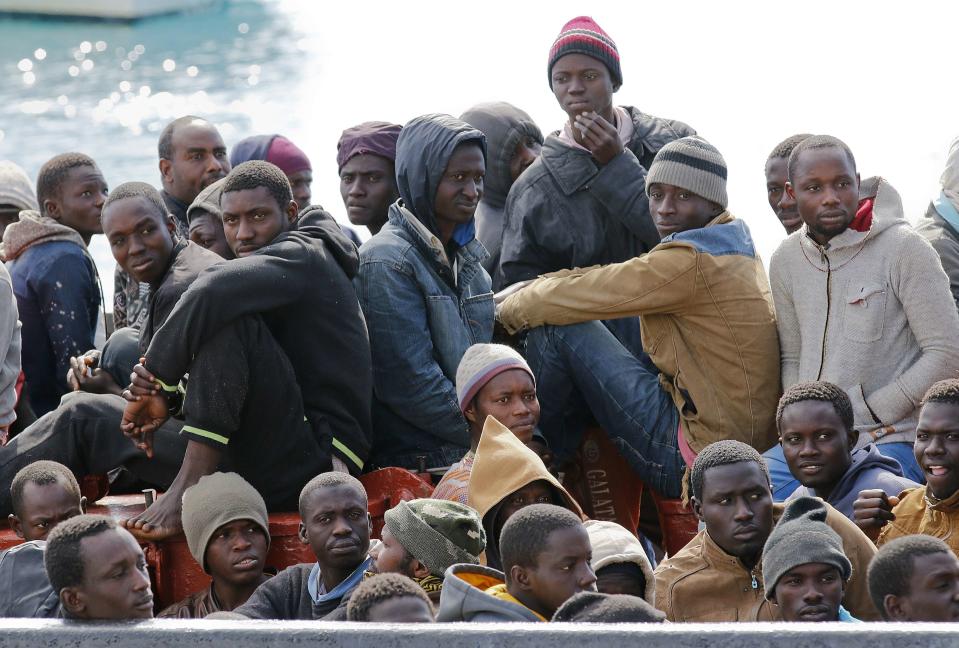 Migrants arrive by boat at the Sicilian harbour of Pozzallo