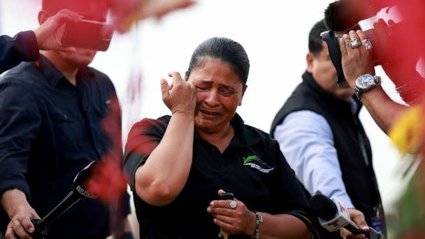 PHOTO: Yvi Beatrice Leon becomes emotional during a visit to a memorial setup near an entrance to the Allen Premium Outlets mall after the mass shooting occurred, May 8, 2023 in Allen, Texas. (Joe Raedle/Getty Images)