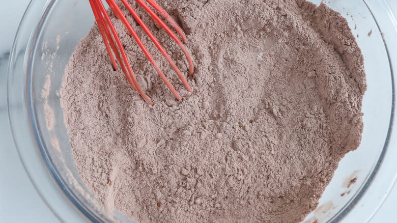 flour and cocoa powder with whisk