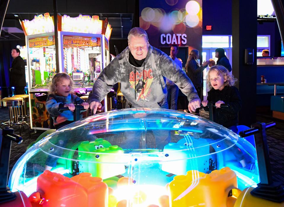 Robert Jensen helps his grandchildren, Baylea and Ashlynn, play a Hungry Hungry Hippos game on Monday, April 4, 2022, at Dave and Buster's at Lake Lorraine in Sioux Falls, South Dakota.