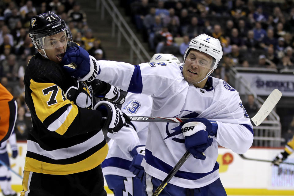 Tampa Bay Lightning's Luke Schenn (2) and Evgeni Malkin (71) fight during the second period of an NHL hockey game in Pittsburgh, Tuesday, Feb. 11, 2020. (AP Photo/Gene J. Puskar)