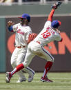 Philadelphia Phillies second baseman Brad Miller, right, and center fielder Odubel Herrera, left, miss a ball hit by Washington Nationals' Victor Robles during the fifth inning of a baseball game, Wednesday, June 23, 2021, in Philadelphia. (AP Photo/Laurence Kesterson)