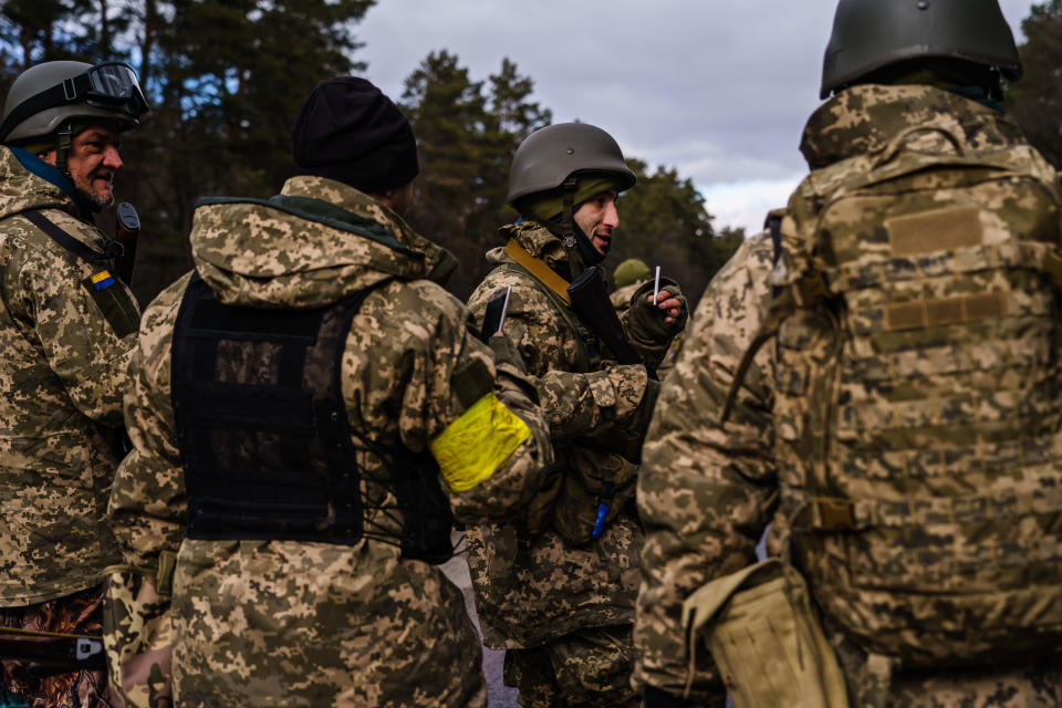 BROVARY, UKRAINE -- MARCH 8, 2022: Soldiers arrive to reinforce one of the final checkpoints before the frontlines where Ukrainian forces are battling invading Russian forces near Brovary, Ukraine, Tuesday, March 8, 2022. (MARCUS YAM / LOS ANGELES TIMES)