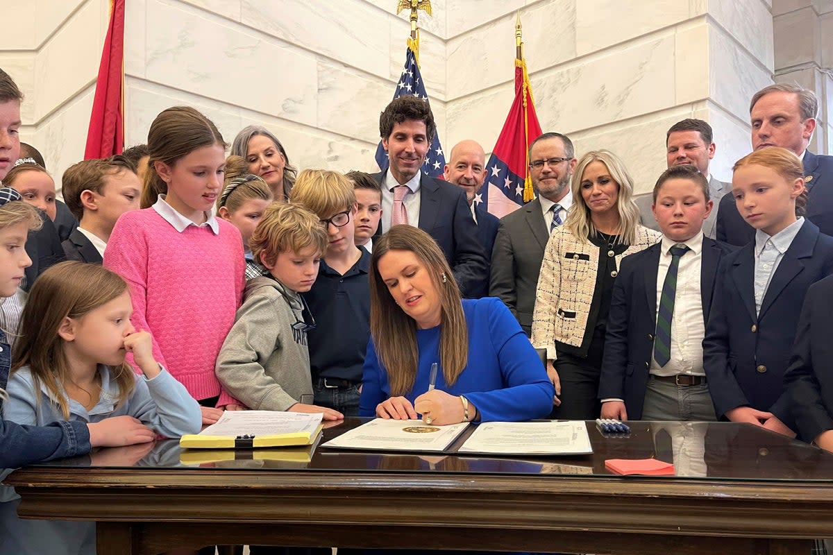 Arkansas Governor Sarah Huckabee Sanders is pictured signing an education overhal bill in March 2023 (AP)