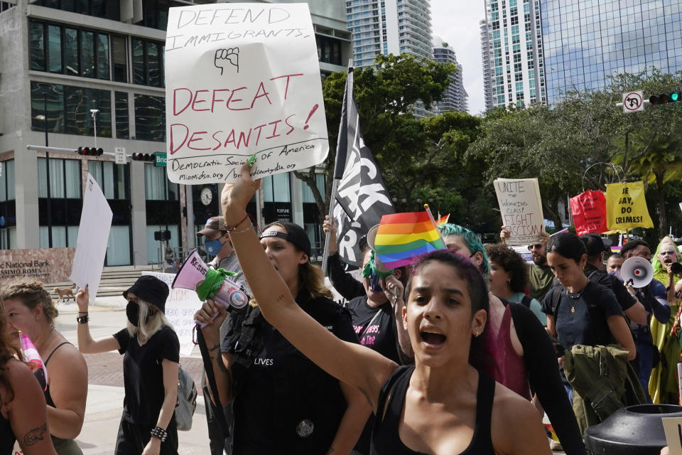 Protesters march near the hotel where Florida Gov. Ron DeSantis is expected to meet with donors Wednesday, May 24, 2023, in Miami. The 44-year-old Republican governor is an outspoken cultural conservative and long seen as Donald Trump's leading rival for the Republican nomination. (AP Photo/Marta Lavandier)
