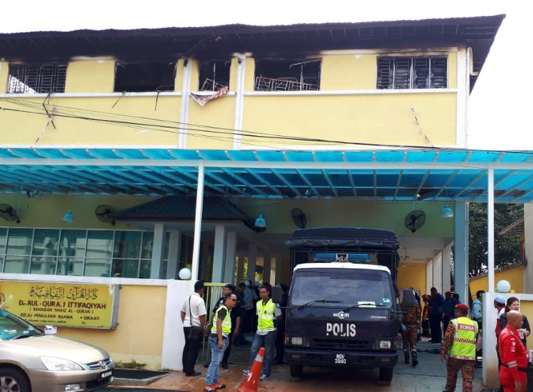 Malaysian Fire and Rescue personnel stand outside the Darul Quran Ittifaqiyah religious school in Kuala Lumpur on September 14, 2017