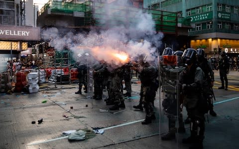 Riot police fired tear gas and water cannon, drenching Hong Kong's biggest mosque with blue dye in what they said was an accident - Credit: Kyle Lam/Bloomberg