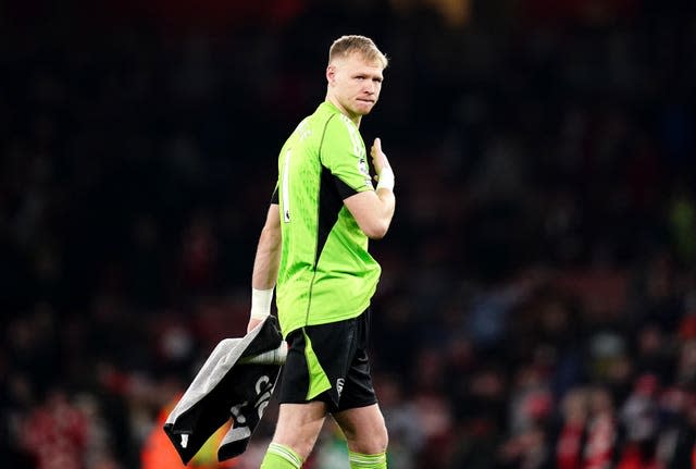 Arsenal goalkeeper Aaron Ramsdale walks off the pitch carrying a towel