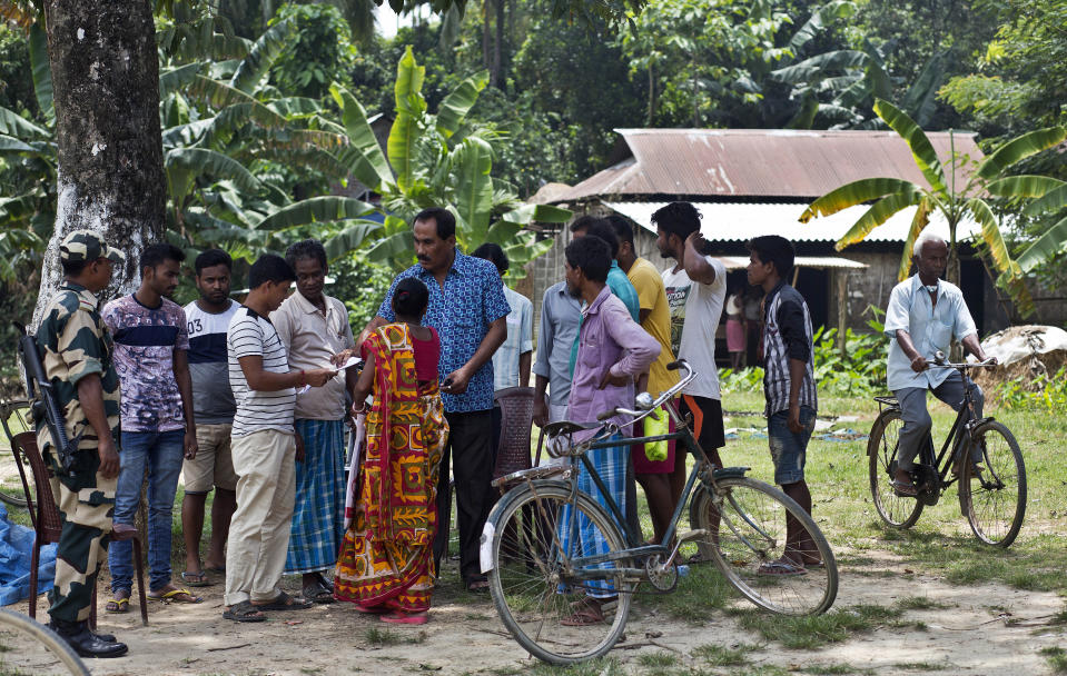 People whose names did not appear in the National Register of Citizens (NRC) draft discusses with an officer as they arrive to collect forms to file appeals in Mayong, 45 kilometers (28 miles) east of Gauhati, India, Friday, Aug. 10, 2018. A draft list of citizens in Assam, released in July, put nearly 4 million people on edge to prove their Indian nationality. Nativist anger churns through Assam, just across the border from Bangladesh, with many believing the state is overrun with illegal migrants. (AP Photo/Anupam Nath)