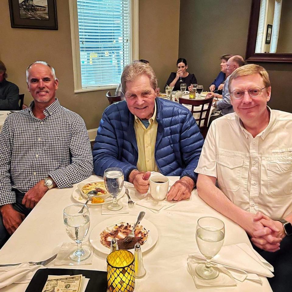Matt Myers, right, Rick Rodriguez, left, and Gus Gustafson at dinner in November.