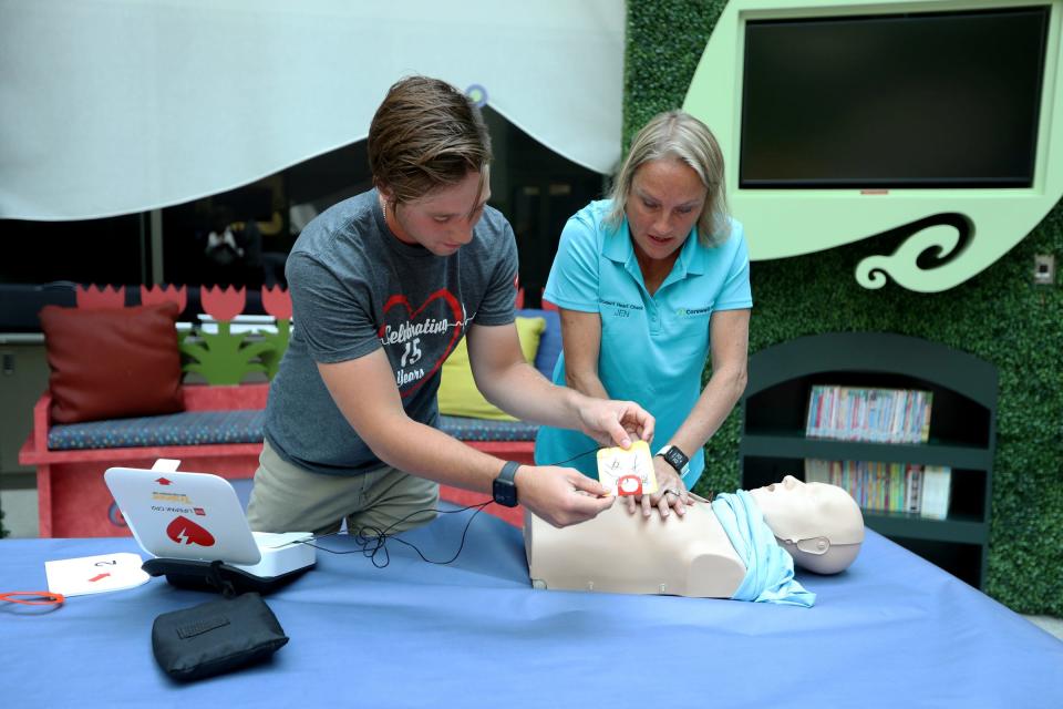 Alex Bowerson, 18, and Jennifer Shea, Beaumont Student Heart Check program manager, demonstrate how to use the Automated External Defibrillator (AED) Thursday, July 20, 2023.