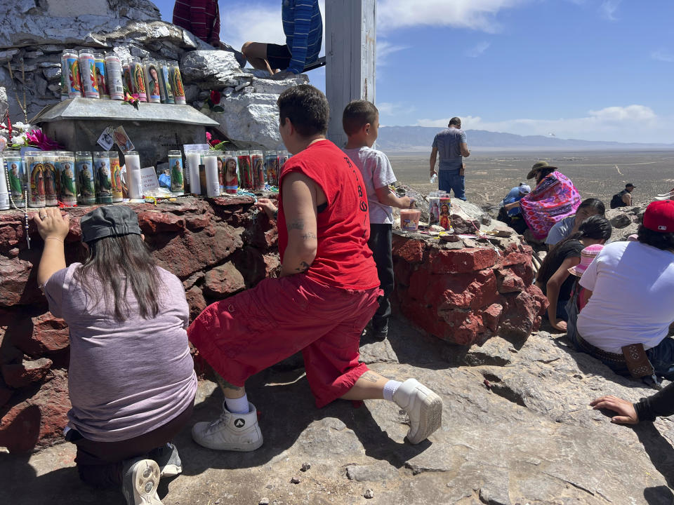 Catholic pilgrims pray at the top of Tome Hill, in Los Lunas, N.M., as part of an annual Good Friday pilgrimage, Friday, April 7, 2023. (AP Photo/Felicia Fonseca)