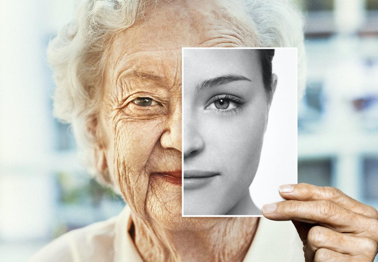 <span class="caption">Is there a genetic switch that can help reverse the aging process?</span> <span class="attribution"><a class="link " href="https://www.gettyimages.com/detail/photo/portrait-of-woman-holding-black-and-white-younger-royalty-free-image/1149473225?adppopup=true" rel="nofollow noopener" target="_blank" data-ylk="slk:Dimitri Otis / Getty Images;elm:context_link;itc:0;sec:content-canvas">Dimitri Otis / Getty Images</a></span>