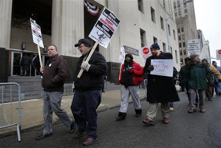 Protesters rally outside the U.S. Federal Courthouse during a bankruptcy ruling by U.S. District Judge Steven Rhodes that Detroit is eligible for the biggest municipal bankruptcy in U.S. history in Detroit, Michigan December 3, 2013. REUTERS/Rebecca Cook