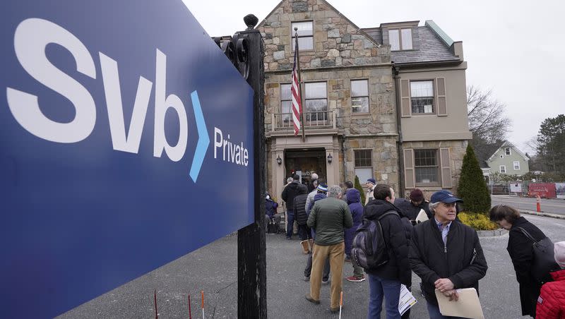 Customers and bystanders form a line outside a Silicon Valley Bank branch location, Monday, March 13, 2023, in Wellesley, Mass. SVB Financial Group filed for Chapter 11 bankruptcy protection, Friday, March 17.