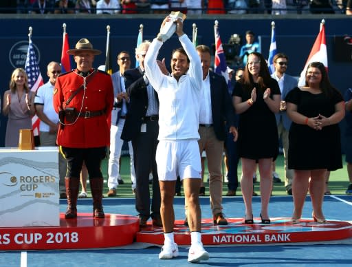 Rafael Nadal of Spain holds up the champions trophy after defeating Stefanos Tsitsipas of Greece in the final of the Rogers Cup, at Aviva Centre in Toronto, on August 12, 2018