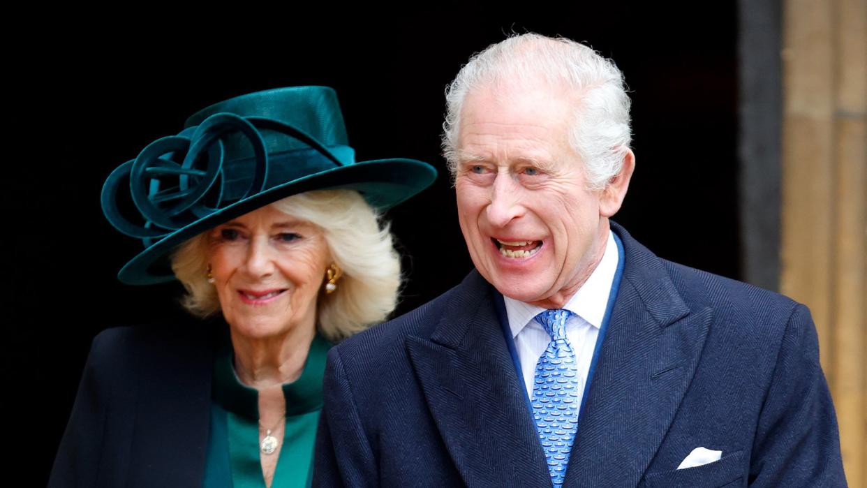 Queen Camilla walking with a smiling King Charles