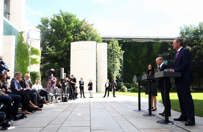 German Chancellor Scholz, chairman of BDA Dulger and chairwoman of DGB Fahimi give a statement in Berlin