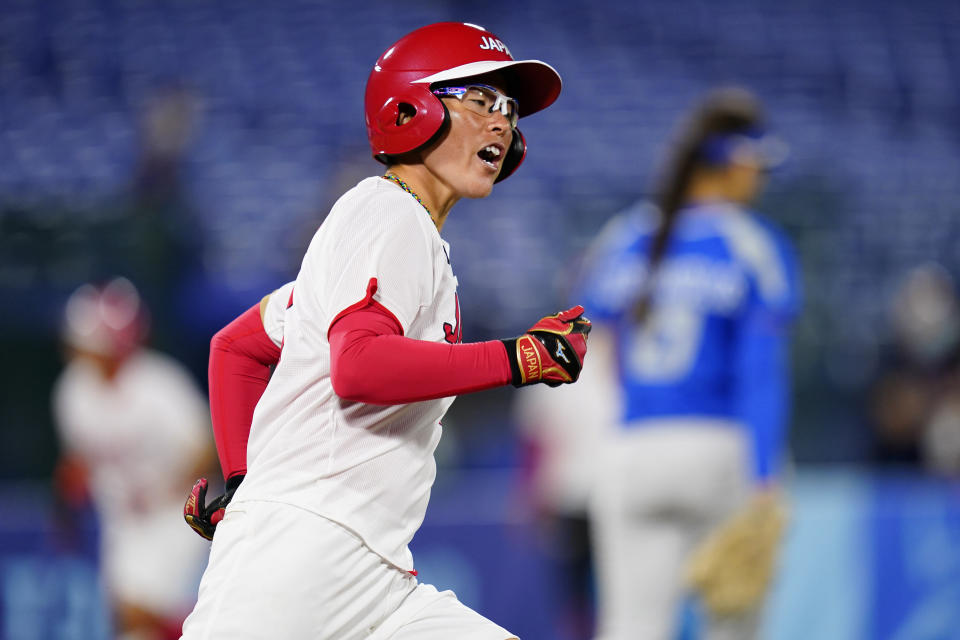 Japan's Yamato Fujita reacts after hitting a three-run home run during a softball game against Italy at Yokohama Baseball Stadium during the 2020 Summer Olympics, Saturday, July 24, 2021, in Yokohama, Japan. (AP Photo/Matt Slocum)