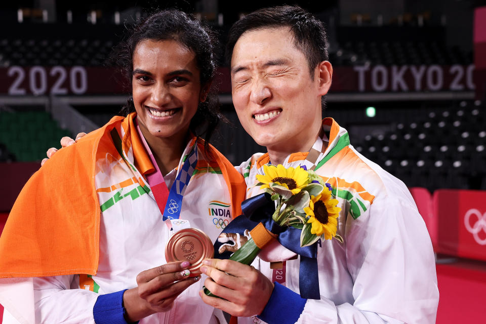 CHOFU, JAPAN - AUGUST 01: Bronze medalist Pusarla V. Sindhu of Team India poses for camera with her coach Park Tae-sang(right) during the medal ceremony for the Women’s Singles badminton event on day nine of the Tokyo 2020 Olympic Games at Musashino Forest Sport Plaza on August 01, 2021 in Chofu, Tokyo, Japan. (Photo by Lintao Zhang/Getty Images)