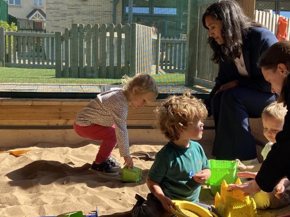 Oxford Mail: Minister plays with children at the nursery