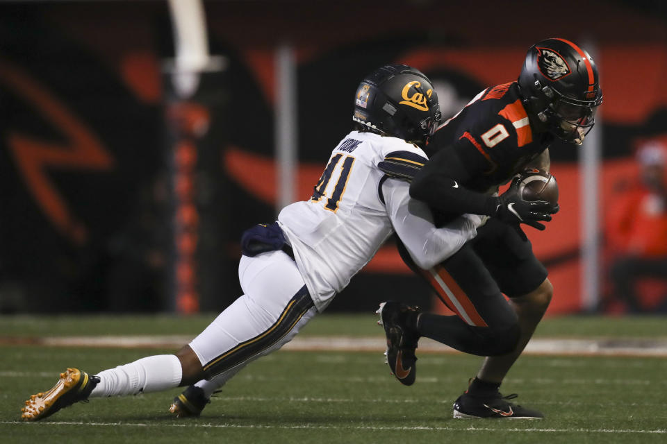 Oregon State wide receiver Tre'Shaun Harrison is brought down by California cornerback Isaiah Young during the first half of an NCAA college football game on Saturday, Nov 12, 2022, in Corvallis, Ore. (AP Photo/Amanda Loman)