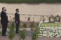 U.S. Secretary of State Mike Pompeo, left, and Secretary of Defence Mark Esper pay their tributes at the National War Memorial in New Delhi, India, Tuesday, Oct. 27, 2020. In talks on Tuesday with their Indian counterparts, Pompeo and Esper are to sign an agreement expanding military satellite information sharing and highlight strategic cooperation between Washington and New Delhi with an eye toward countering China. (Jewel Samad/Pool via AP)