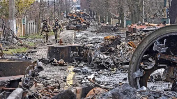 PHOTO: Soldiers walk amid destroyed Russian tanks in Bucha, on the outskirts of Kyiv, Ukraine, April 3, 2022.   (Rodrigo Abd/AP)